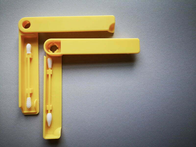 two plastic yellow q-tips in plastic cases